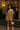 Model in striped taupe set with heeled ankle boots and shoulder bag outside hotel