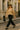 Beige hollow knit sweater styled with black trousers and loafers for city chic