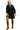 Woman wearing a black dress with gold trim and brown knee-high boots on a white background
