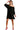 Model wearing black velvet mini dress with red heels, perfect for a party-ready look.