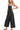 Side view of woven spaghetti strap overalls showing relaxed silhouette for summer