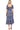Back view of tiered blue dress with trim accents and natural waist for a feminine fit