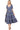 Women's blue tiered midi dress front view with puff sleeves and decorative trim details