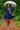 Walking in bohemian mini dress with embroidery, lavender sandals and umbrella, lush park after rain