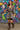Walking in Boho Floral Mini Dress with belt and boots, mural wall background daylight.