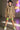 Woman in paisley mini dress with neon green biker shorts, white sneakers and headphones
