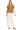 Woman wearing a brown knitted sweater and white pants on a white background