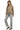 Woman wearing a beige sweater and gray pants on a white background