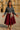 Woman posing in charcoal ribbed half zip sweater with burgundy skirt and flats, palace square daylight.