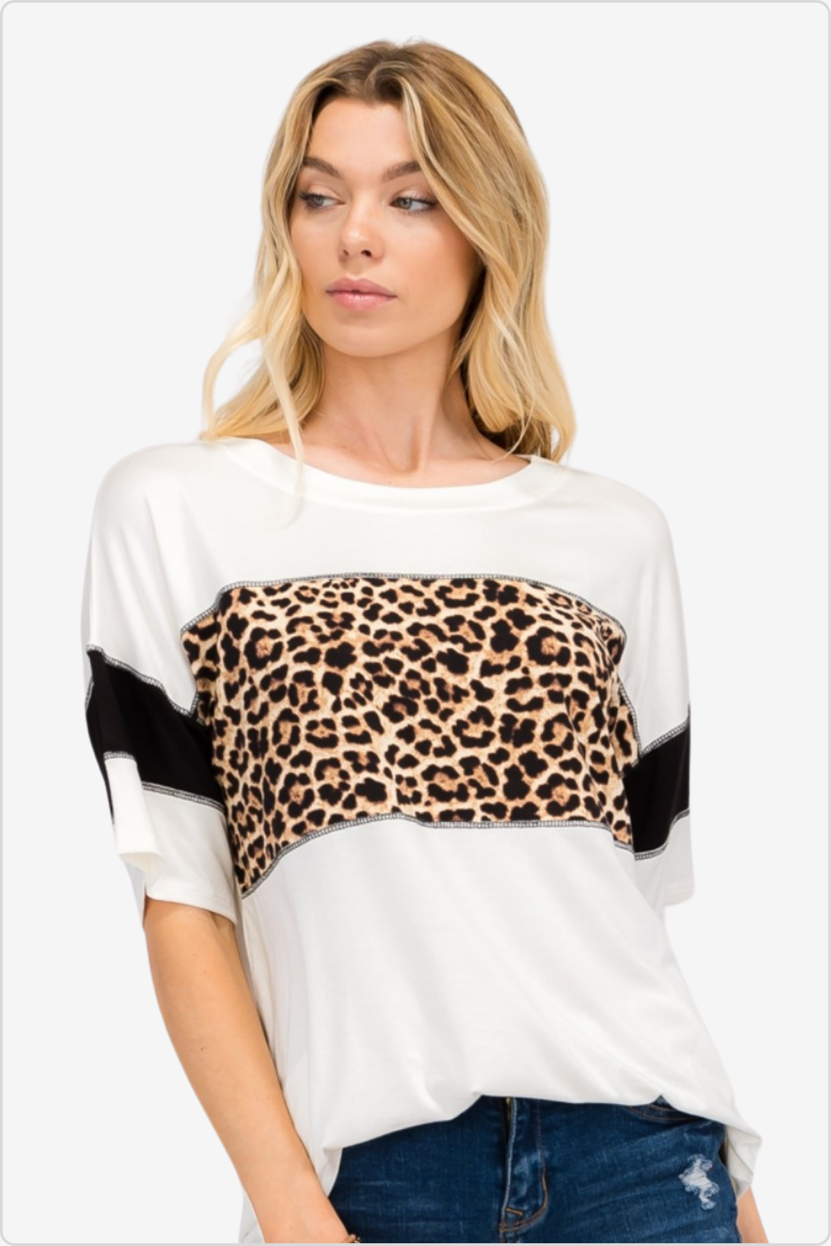 Woman in white top with leopard print detail, a bold urban fashion statement.