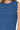 Close-up of ribbed fabric texture and ruffle seam at armhole.