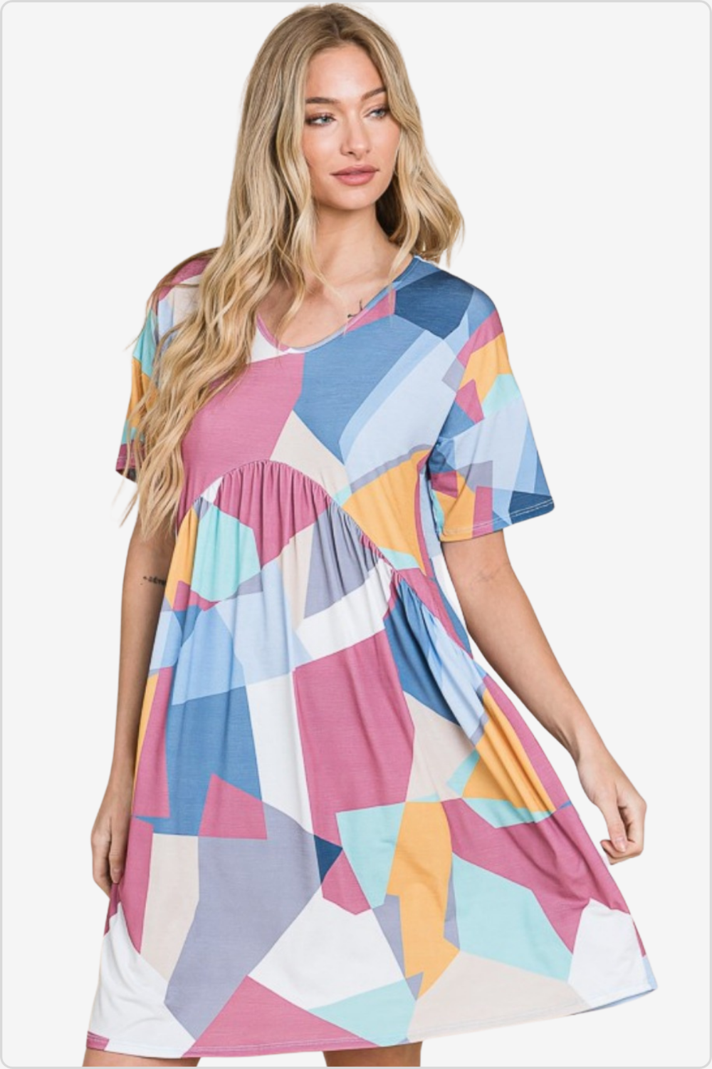 Woman in a dress with bold geometric shapes, radiating contemporary elegance.