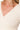 Close-up of cream ribbed crop pullover with wrap style front V neckline and long sleeves