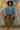 Standing in cropped denim jacket with combat boots and cargo pants, in front of graffiti wall, overcast light