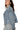 Side view of dusty blue denim jacket showing cropped hem and relaxed oversized fit