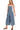 Side view of medium wash denim wide leg overalls highlighting pocket placement.