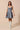 Model wearing denim flare dress styled for casual daytime outfit