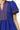 Close-up of dark blue embroidery on neckline with geometric stitching
