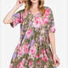 Woman in olive floral dress exudes boho chic summer vibes.