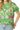Close-up of pink floral print on green fabric and elastic puff sleeve cuff