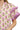 Close-up of pink purple floral print with cotton texture and ruffle edge