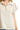 Close-up of cream cotton-blend texture and raw frayed hemline