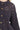 Close-up of midnight eyelet lace knit with gold-tone button detailing