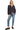Woman wearing a dark blue embroidered shirt and jeans on a white background