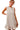 Front view showing sleeveless cut and round neckline in bow print
