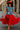 Denim jacket with red ruffle skirt, red heels and hat styled for bold statement outfit