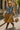 Denim jacket with tan skirt, brown boots and hat styled for chic streetwear