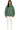 Person wearing a green hoodie and white pants on a white background