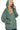 Person wearing a green hoodie on a white background