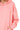 Close-up of pink scuba fabric showing texture and stretch at seam