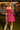 Laughing at food truck in paisley off-shoulder dress with cowboy boots and pearl jewelry, evening lights