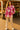 Woman wearing Plaid Fleece Shacket with beige pants and loafers, standing at farmers market in sunlight