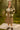 Woman standing in Plaid Fleece Shacket with clogs and socks, on blanket in forest, soft morning light