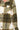 Close-up of plaid fleece fabric showing olive and cream check pattern