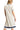Back view of cream midi dress with navy sleeve trim and clean silhouette