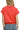 Back view of coral red polo sweatshirt with oversized fit and ribbed trim