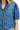 Close-up of a blue denim shirt with a blurred background