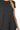 Close-up view of black rayon fabric showing flowy round hem and soft texture.