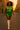 Walking in retro floral blouse with green mini skirt and white boots, sunset city street