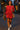 Woman in ruby ribbed outfit with white sneakers and saxophone, walking on Havana street, night lights