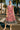 Woman standing in Ruffled Cap Sleeve Midi Dress with white heels, on sunny street with palm trees