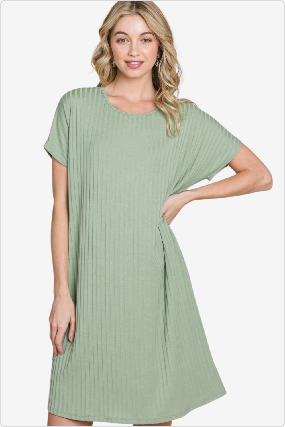Woman in a sage green ribbed dress, embodying a relaxed yet chic aesthetic.