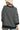 Person wearing a black and white striped sweater on a white background