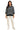 Woman wearing a black and white striped sweater with white pants on a white background
