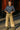 White model in striped knit top with khaki cargo pants and boots in city street setting