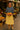 African American model in striped knit top with yellow skirt and green flats at fruit market